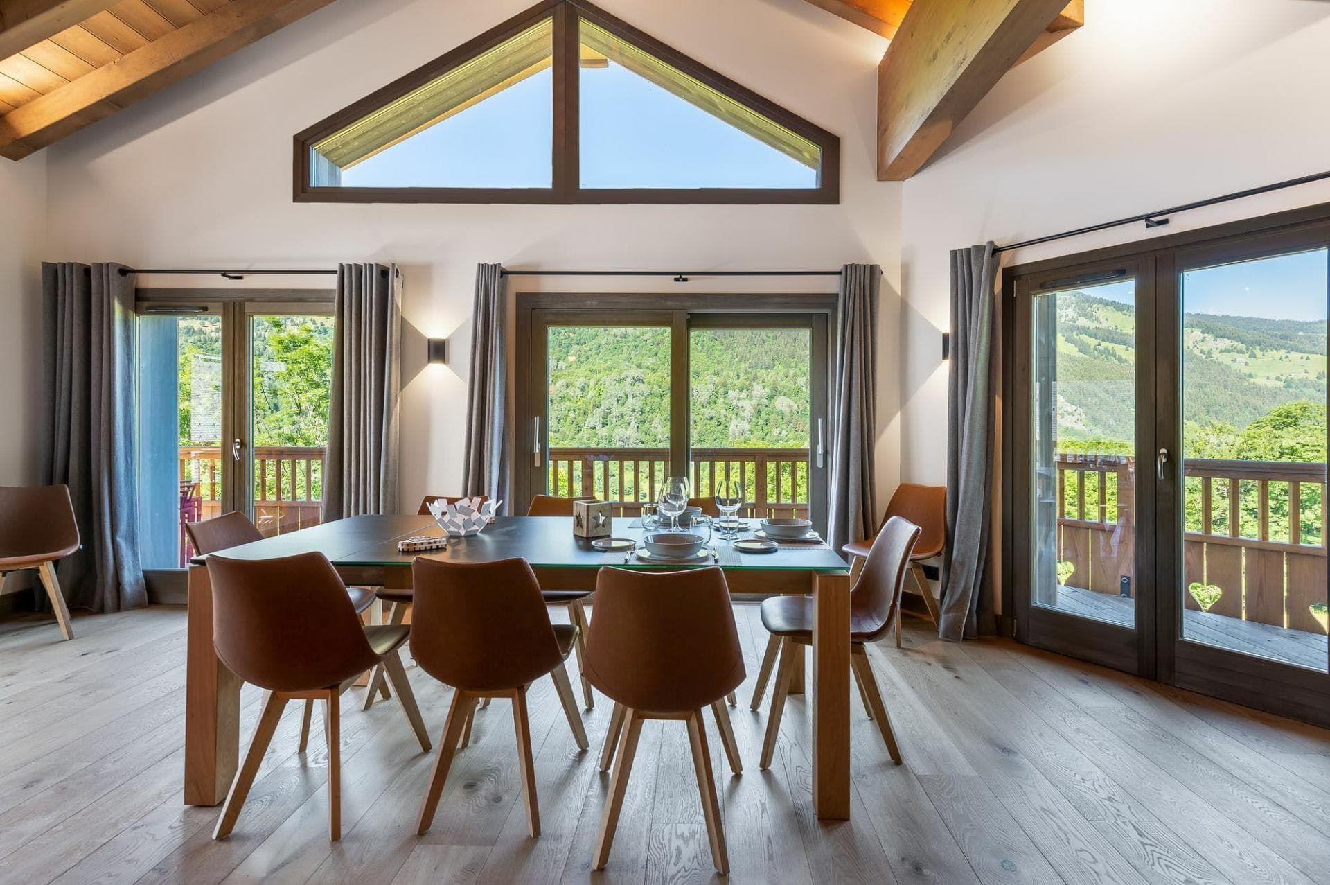 Dining area opening onto the balcony and mountain views