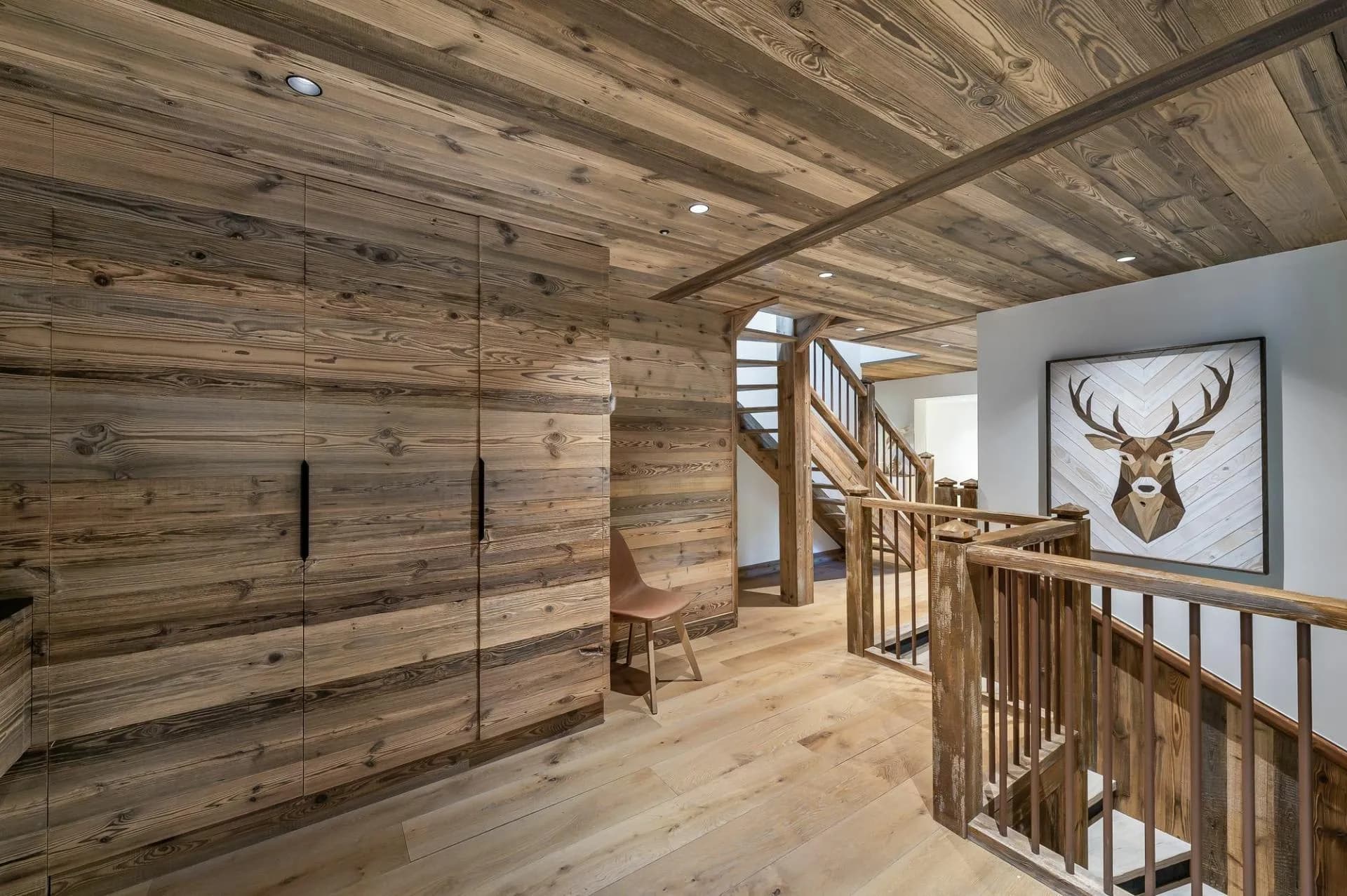 Timber-lined landing connecting the apartment's upper levels