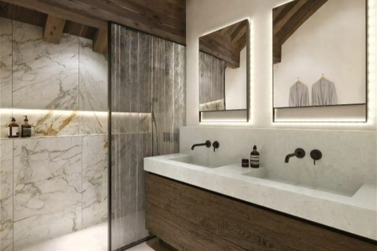 En-suite shower room with twin basins and illuminated mirrors