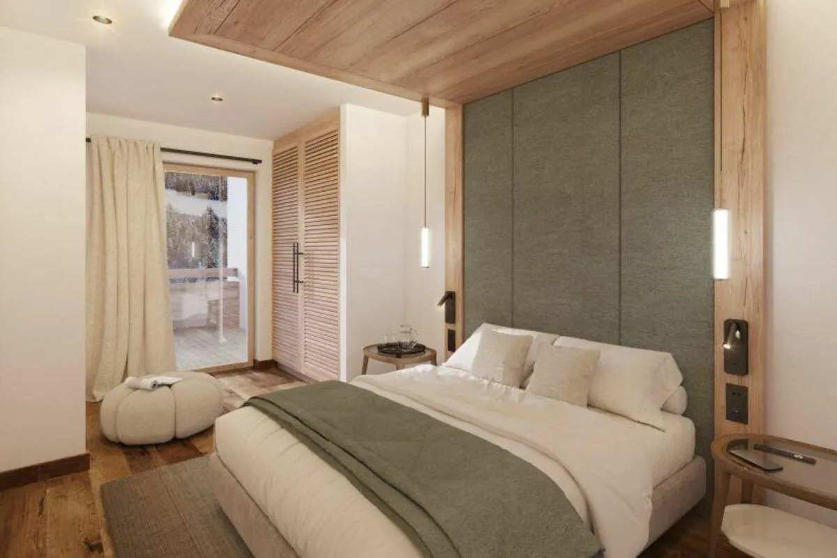 Double bedroom with integrated bedside lighting and balcony doors