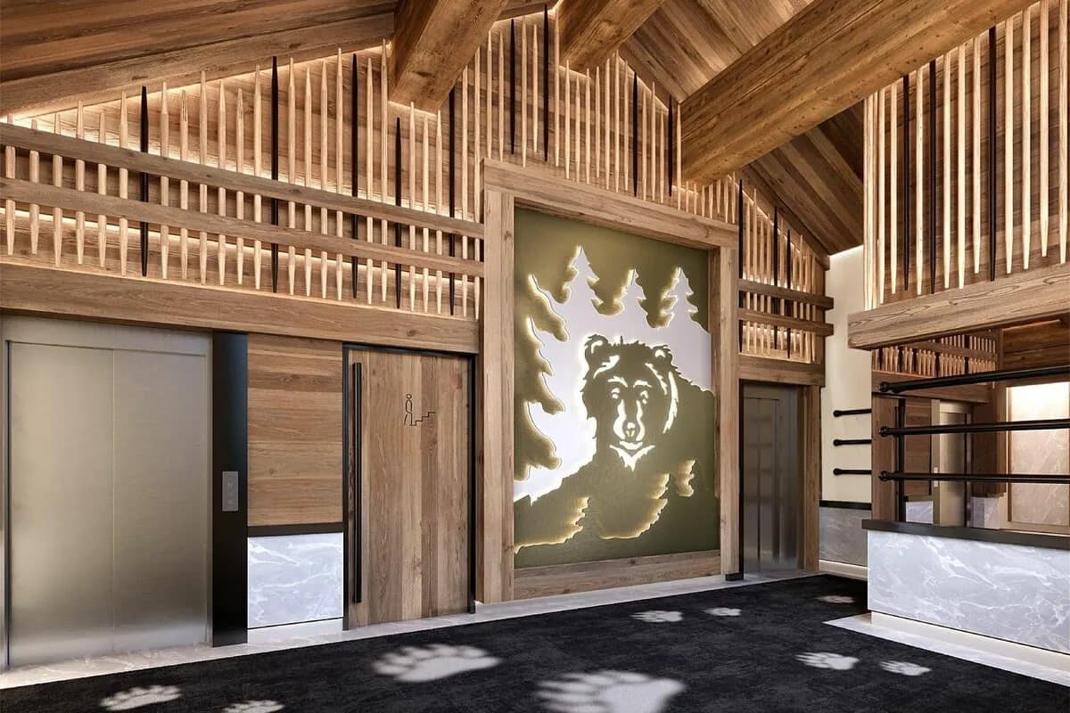 Wood-lined residence lobby with lift and ski storage
