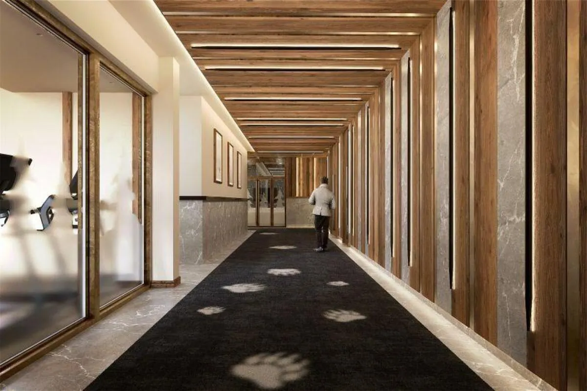 Wood-lined corridor leading to the shared fitness room
