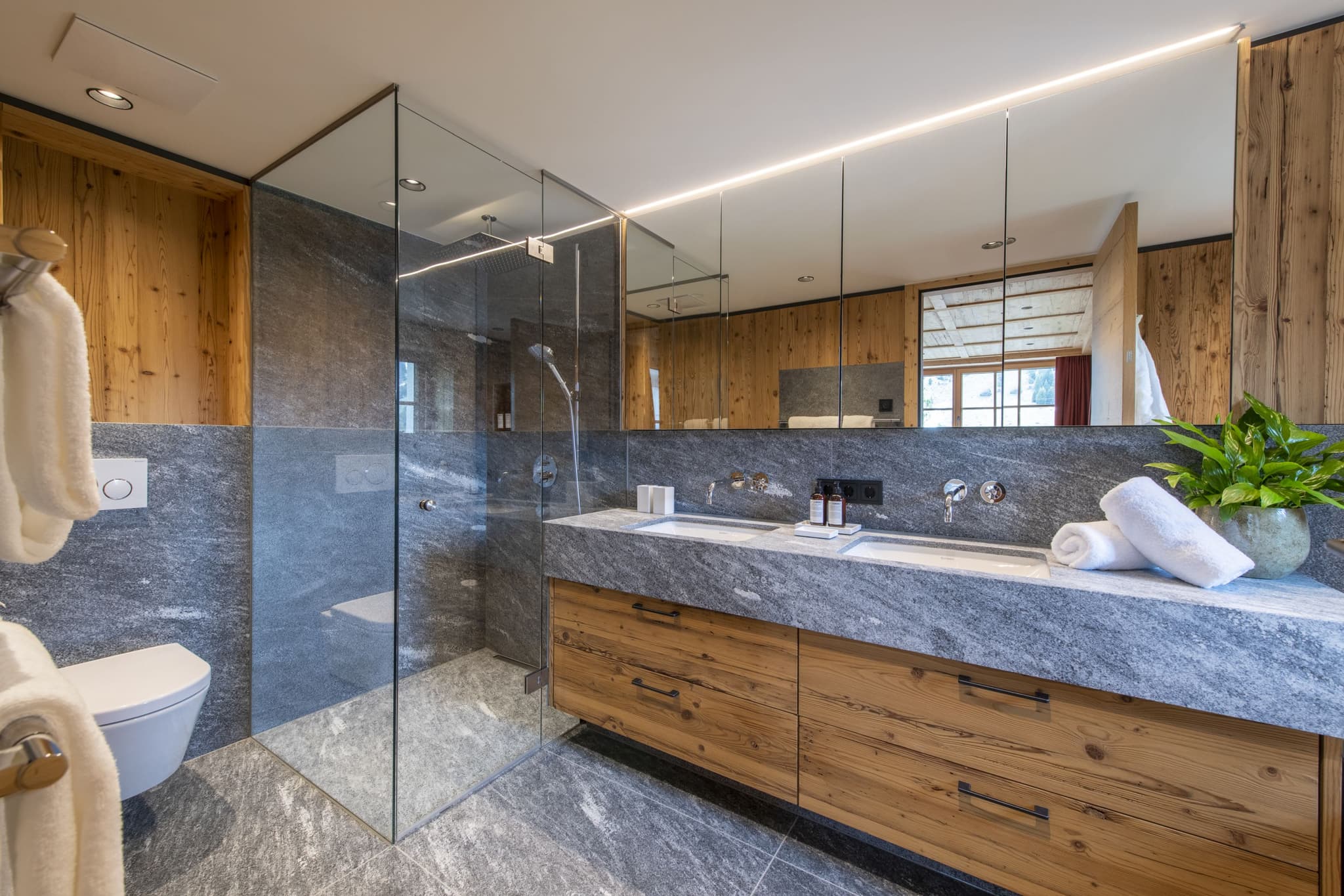 Bathroom with dual vanity and walk-in glass shower