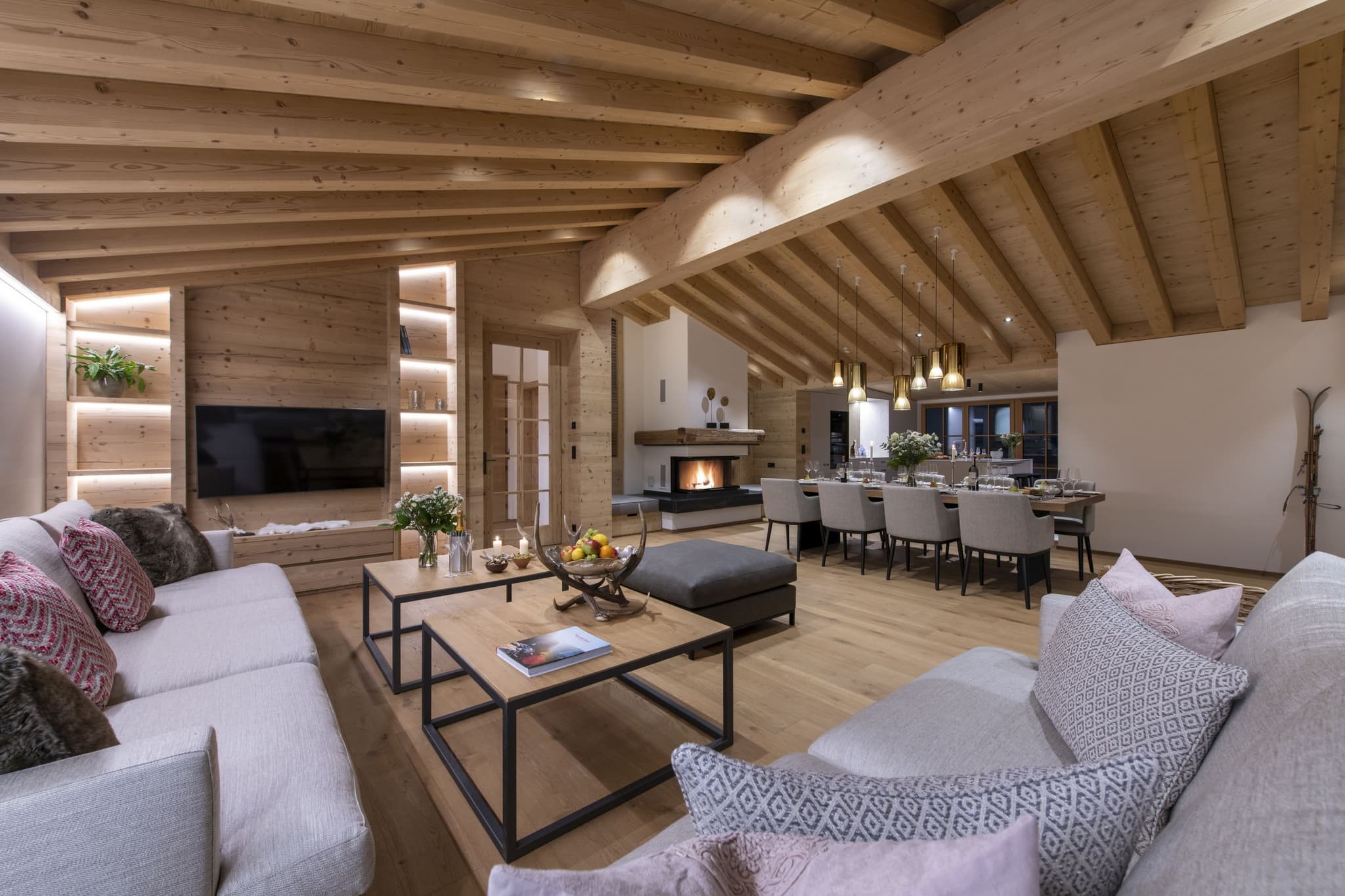 Open-plan living area with wood-burning fireplace and dining seating for 10