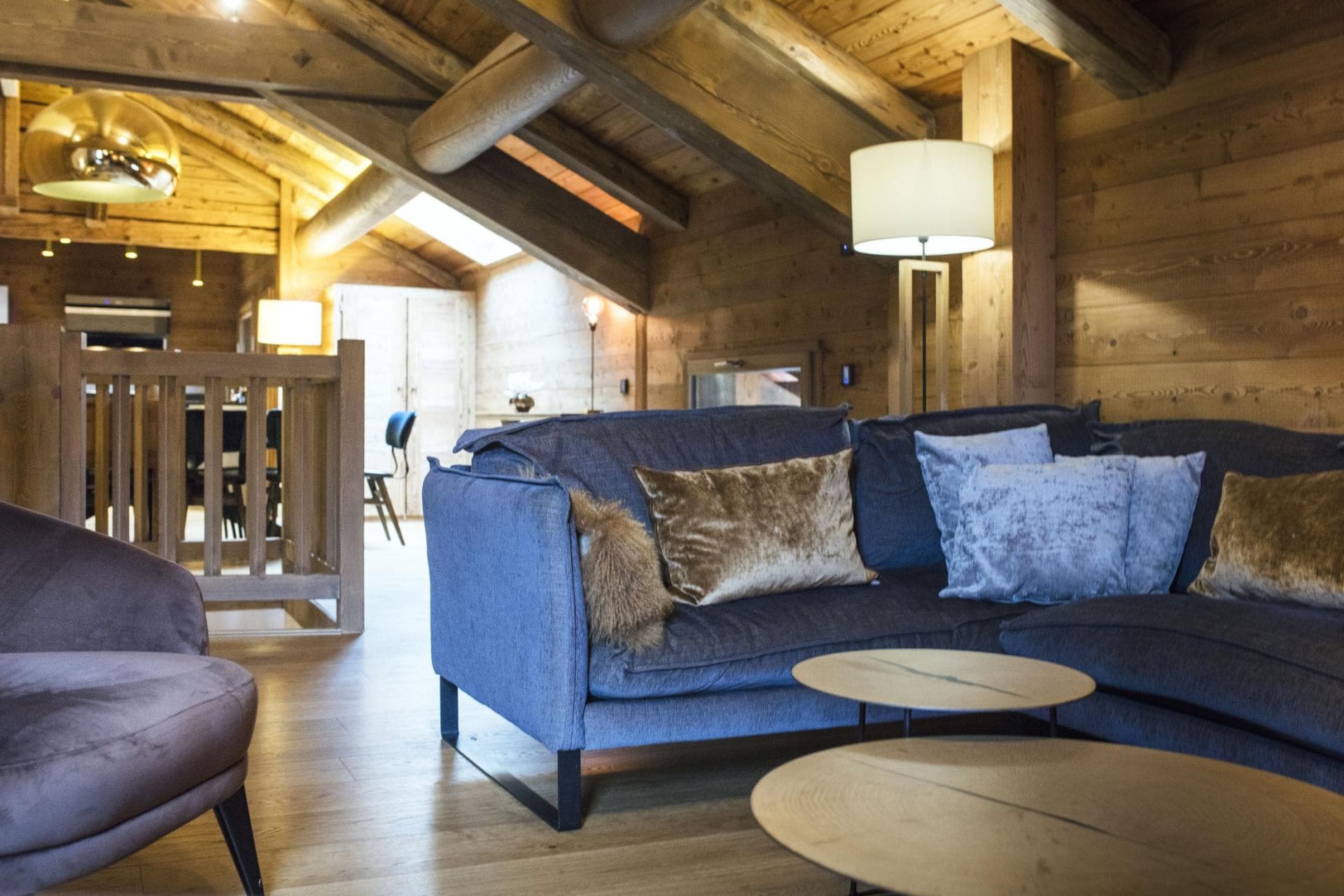 Upper-level living area with vaulted timber ceilings and sectional seating