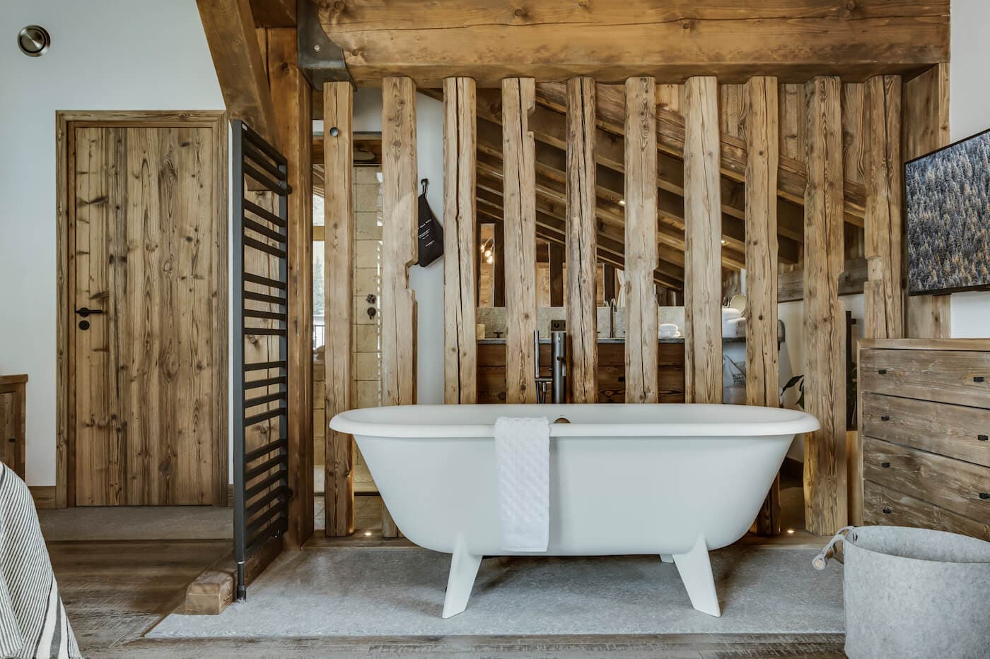 En suite bathroom with freestanding soaking tub and heated towel rack