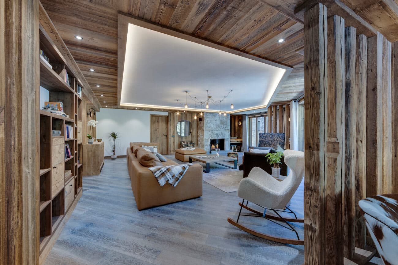 Living area with wood-burning fireplace and recessed cove lighting