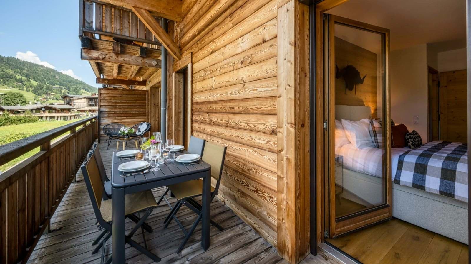Private balcony with four-person dining table and bedroom access