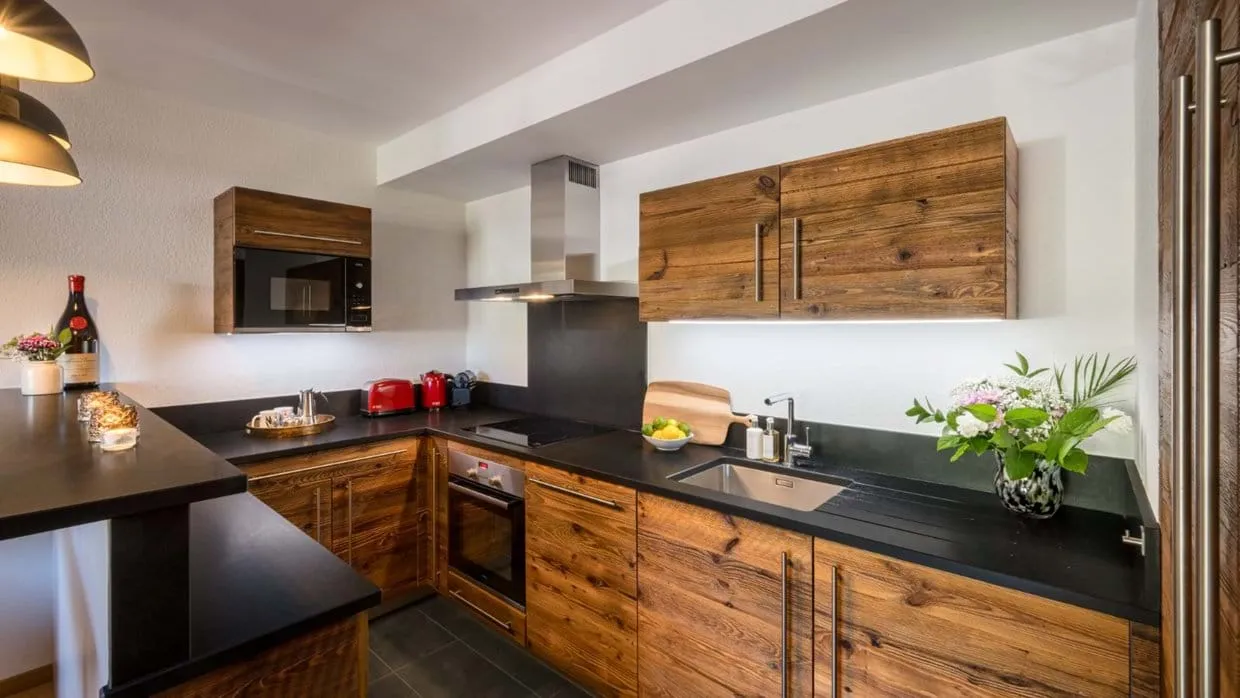 Fully equipped kitchen with an induction hob and timber cabinetry