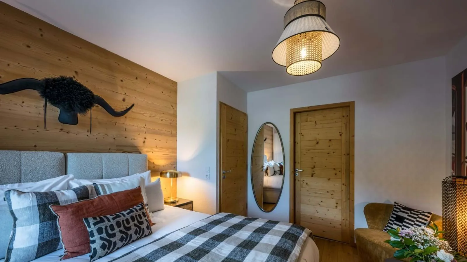 Double or twin bedroom with a timber feature wall and bedside lights