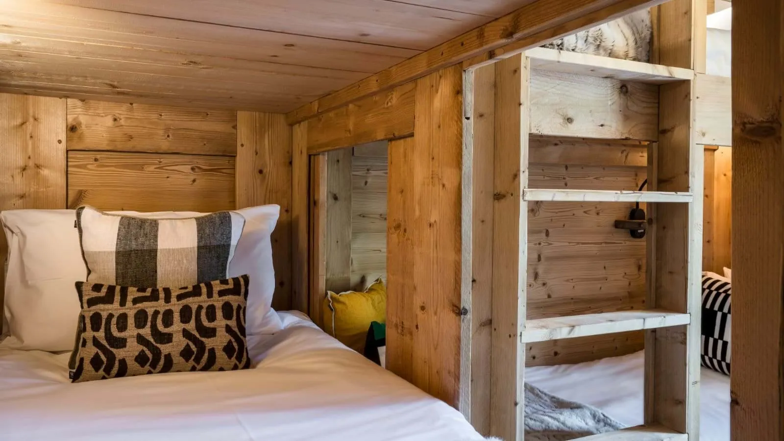 Built-in bunk beds with ladders, reading lights and under-bed storage