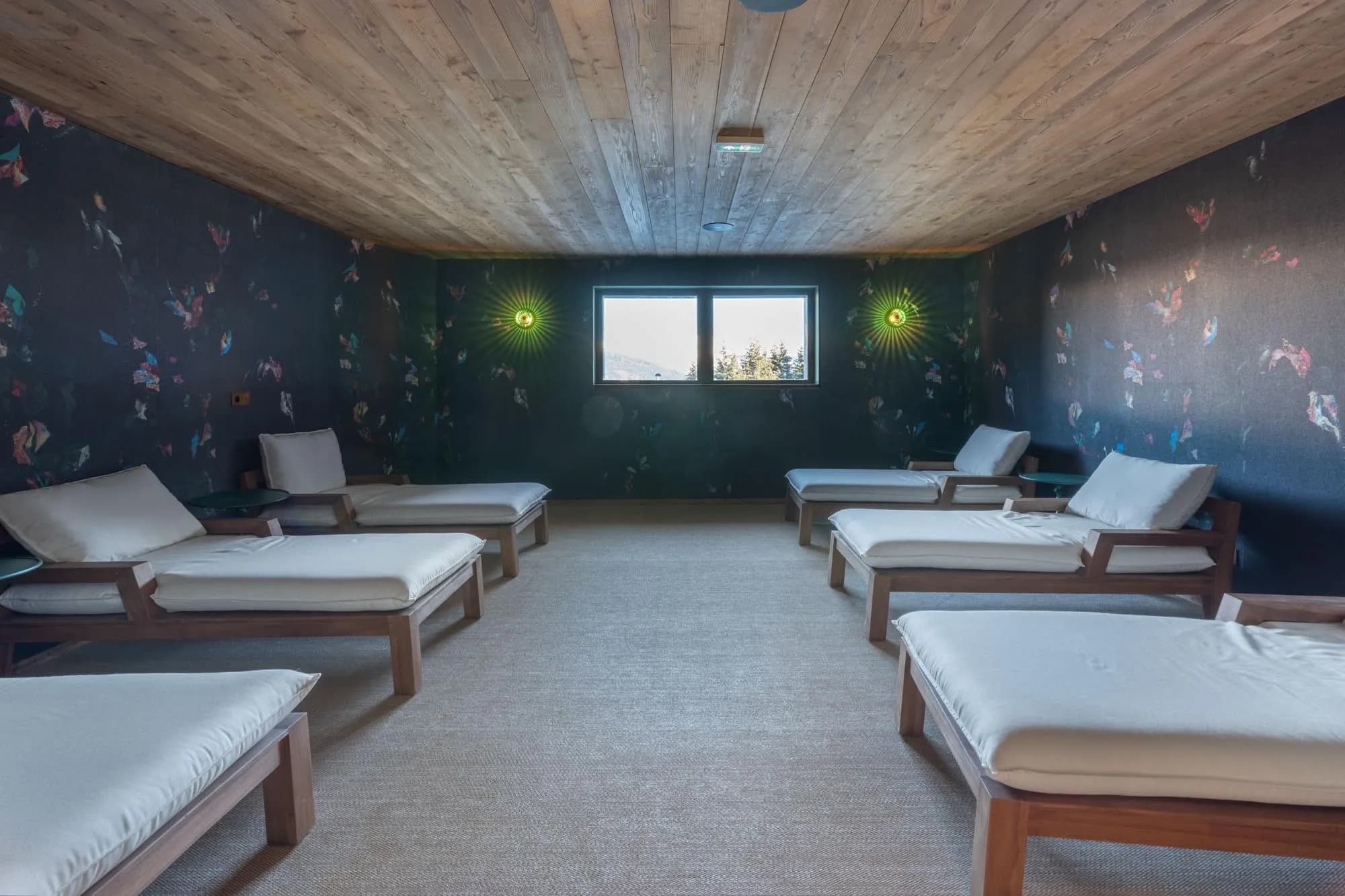 Relaxation room with cushioned loungers in the shared wellness area