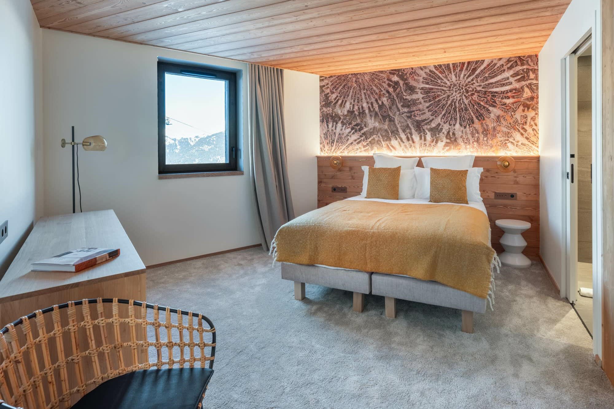 Guest bedroom with queen bed, mountain views, and ensuite bathroom access