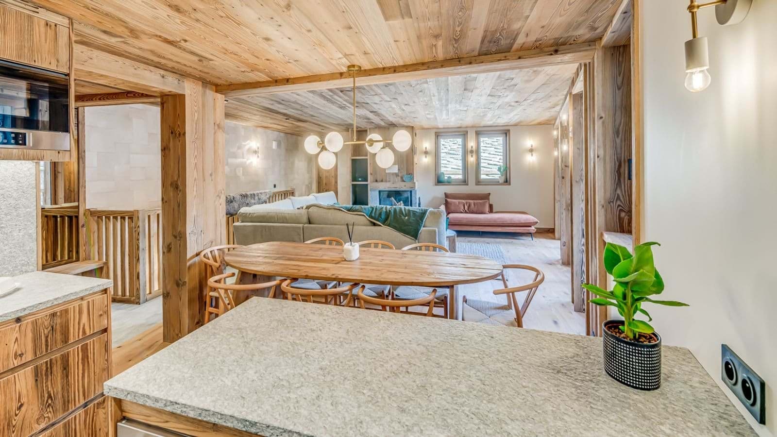 Open-plan living area with 8-person dining table and wood-burning fireplace