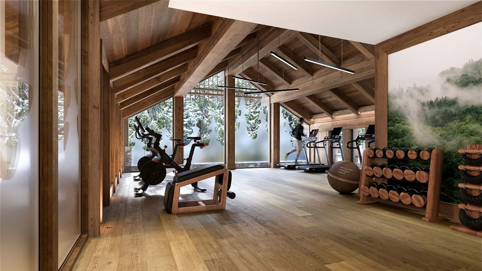 Home gym with Peloton bikes, treadmills, and floor-to-ceiling forest views