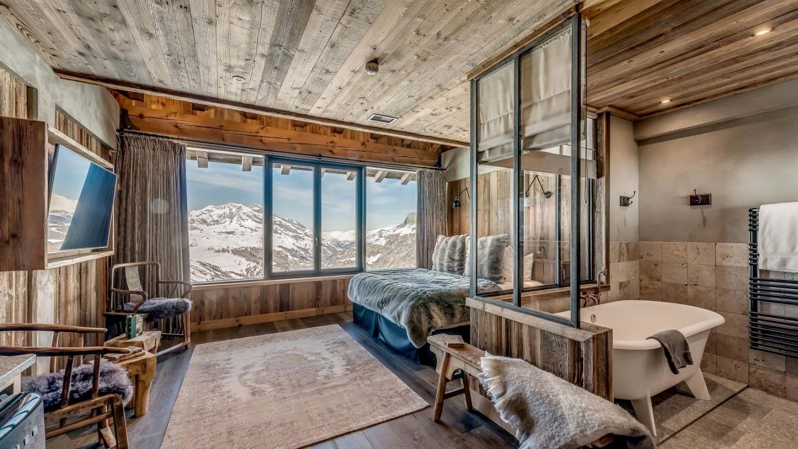 Primary suite with king bed, mountain views, and in-room soaking tub