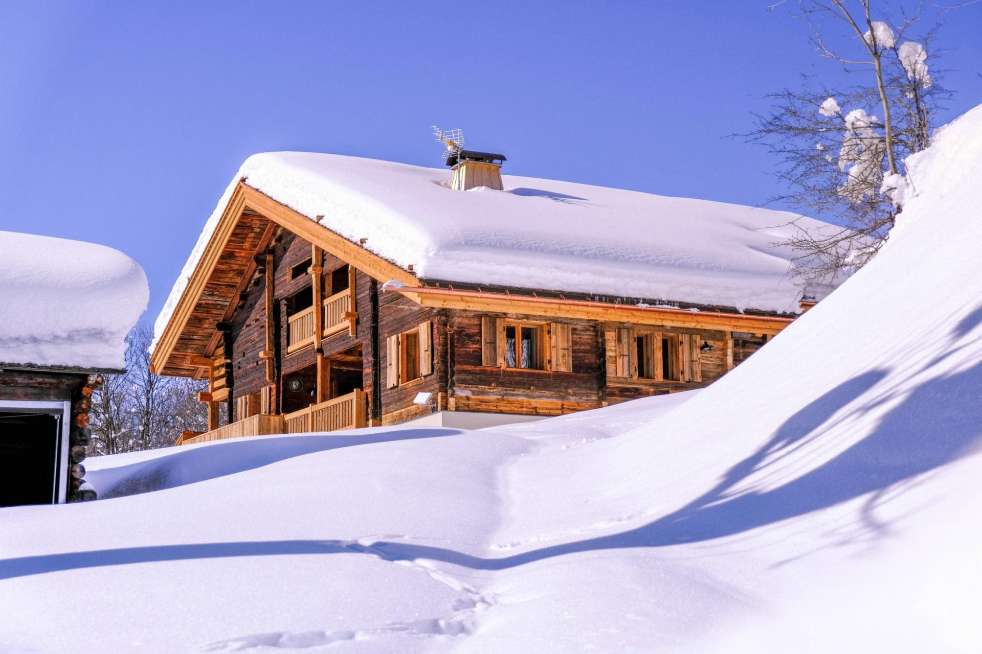 Ski-in/ski-out chalet exterior with private balcony and traditional timber facade