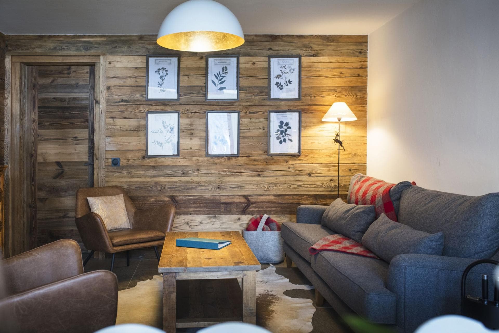 Living area with reclaimed wood feature wall and cowhide rug