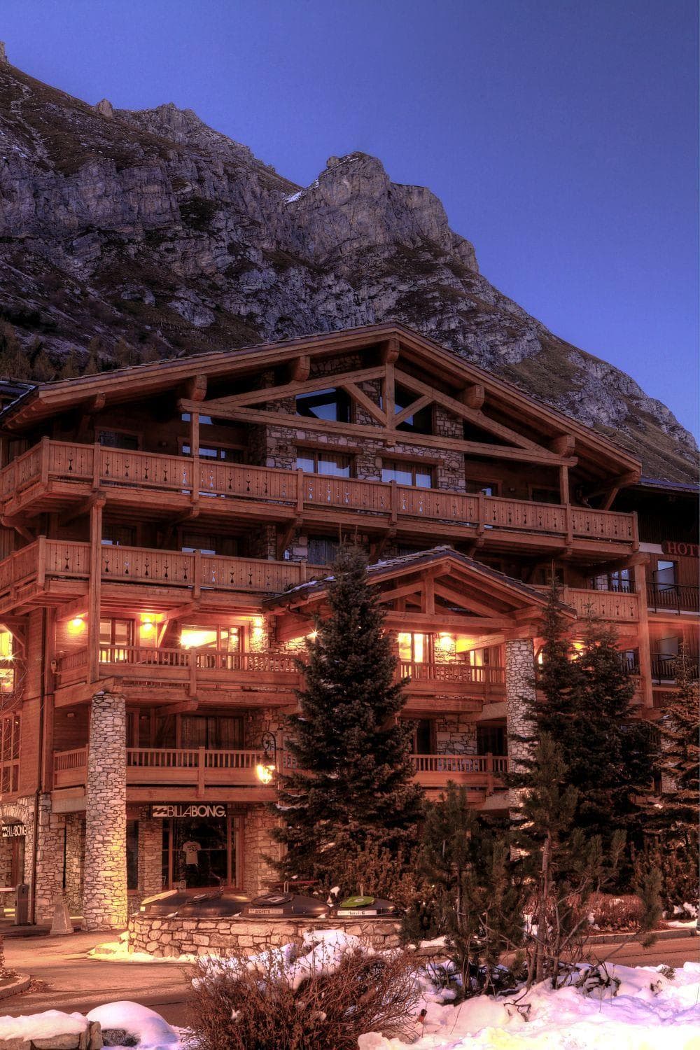 Ski-in/ski-out chalet exterior with private balconies and mountain peak backdrop