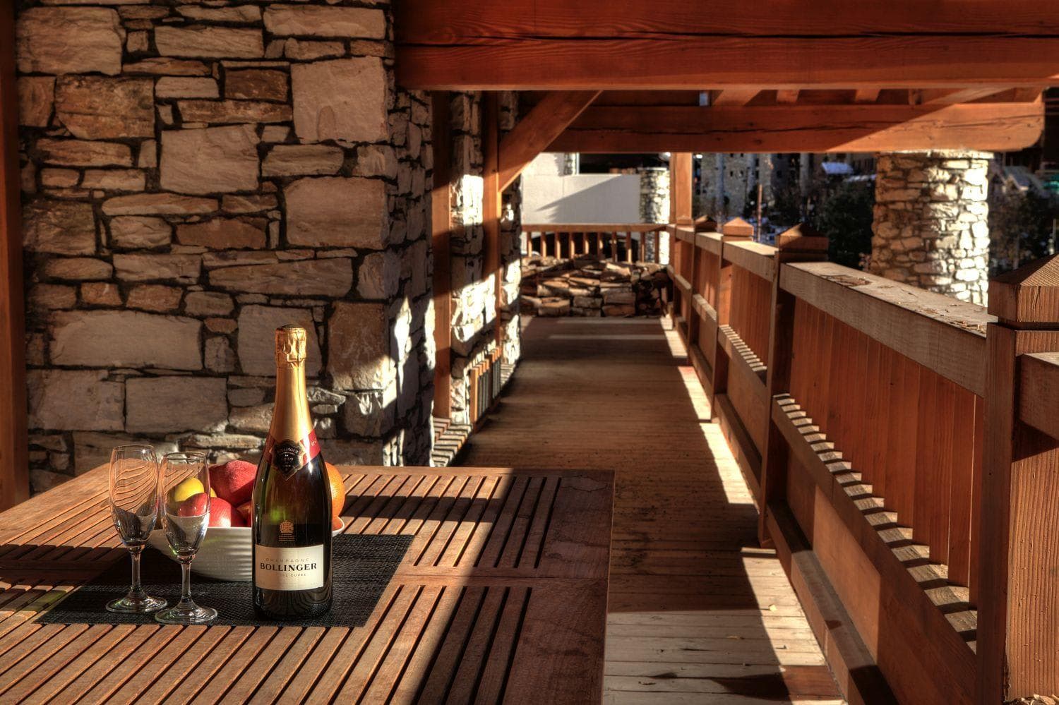 Covered timber balcony with stone accents and village views