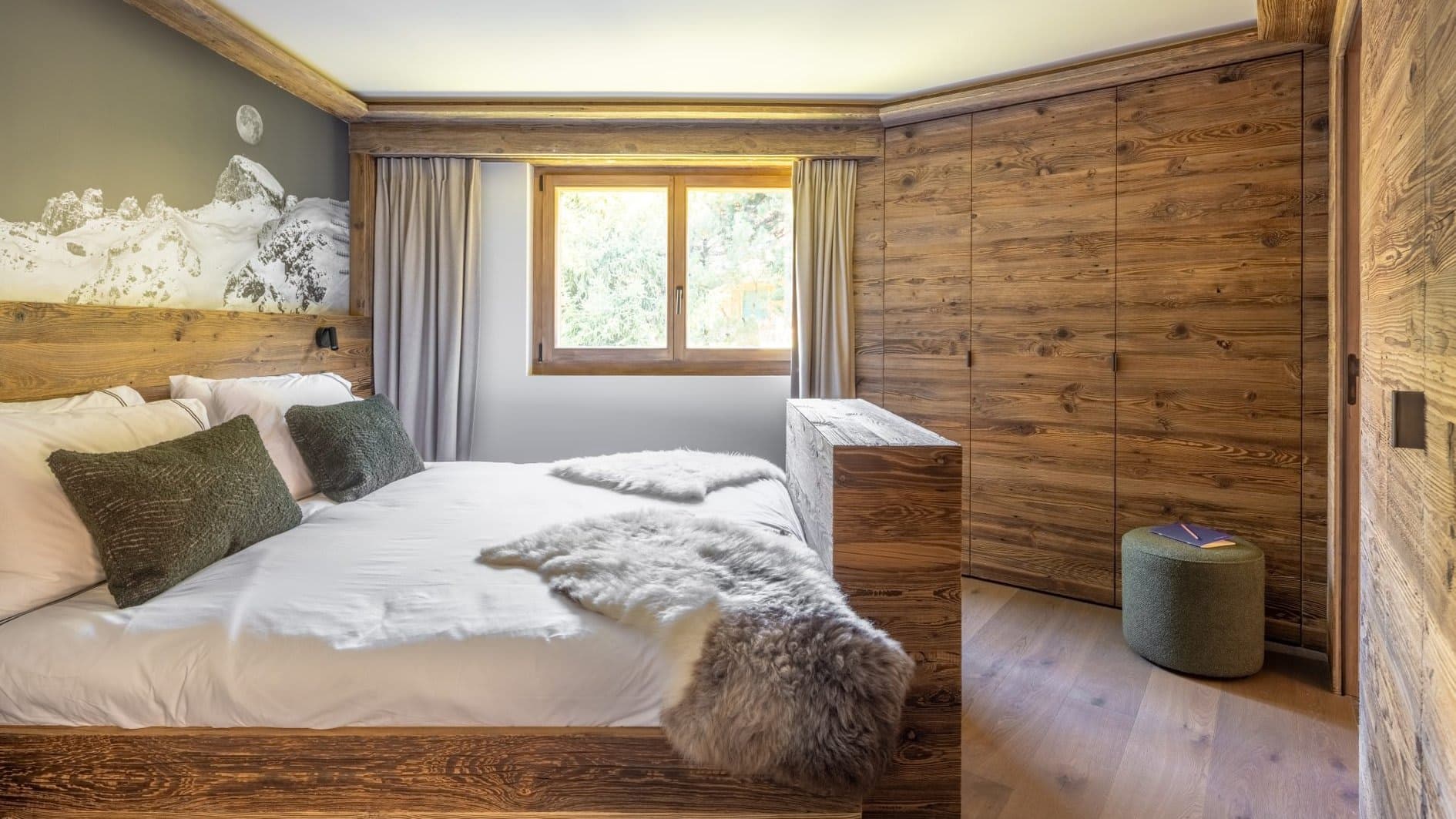 Bedroom with king bed and floor-to-ceiling wooden wardrobes