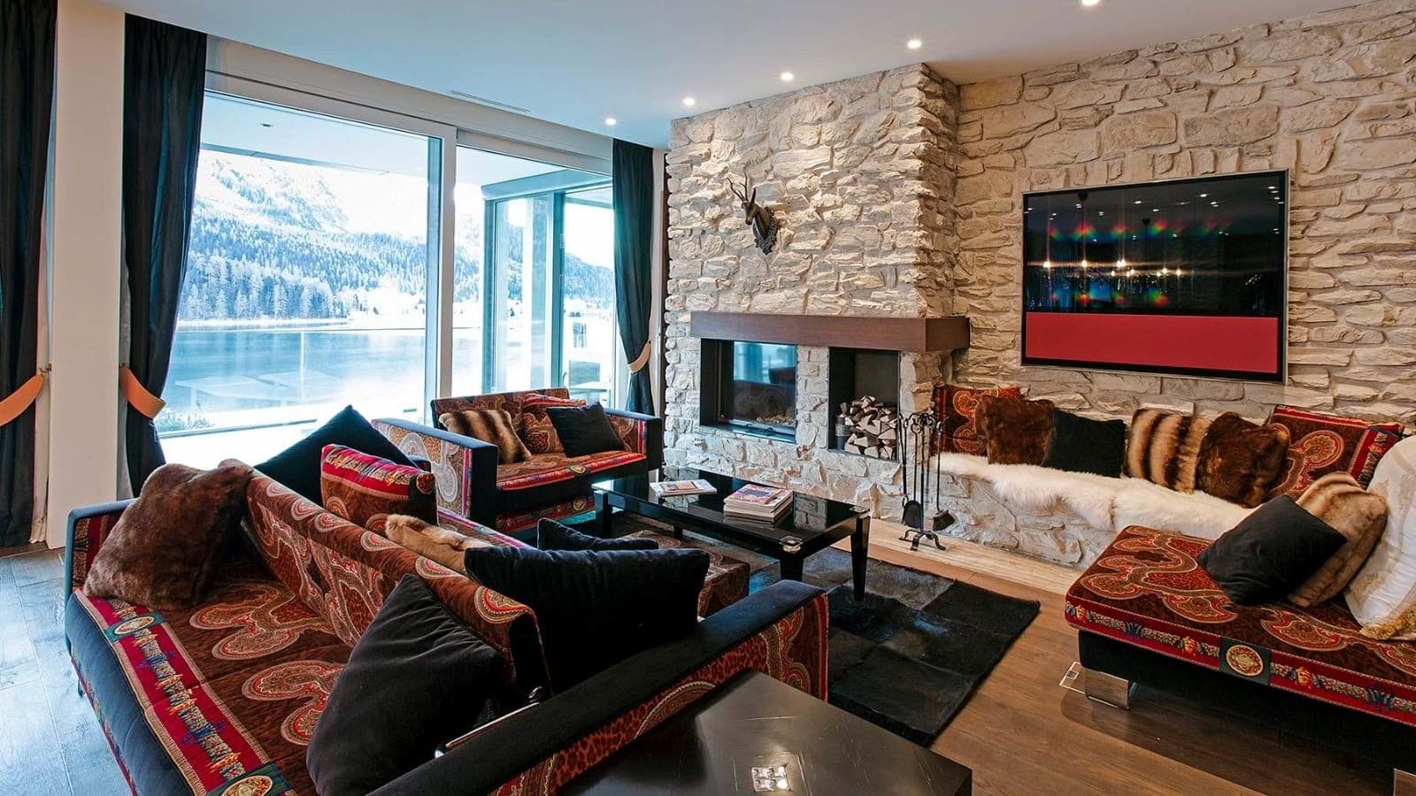 Living area with wood-burning fireplace and lake views