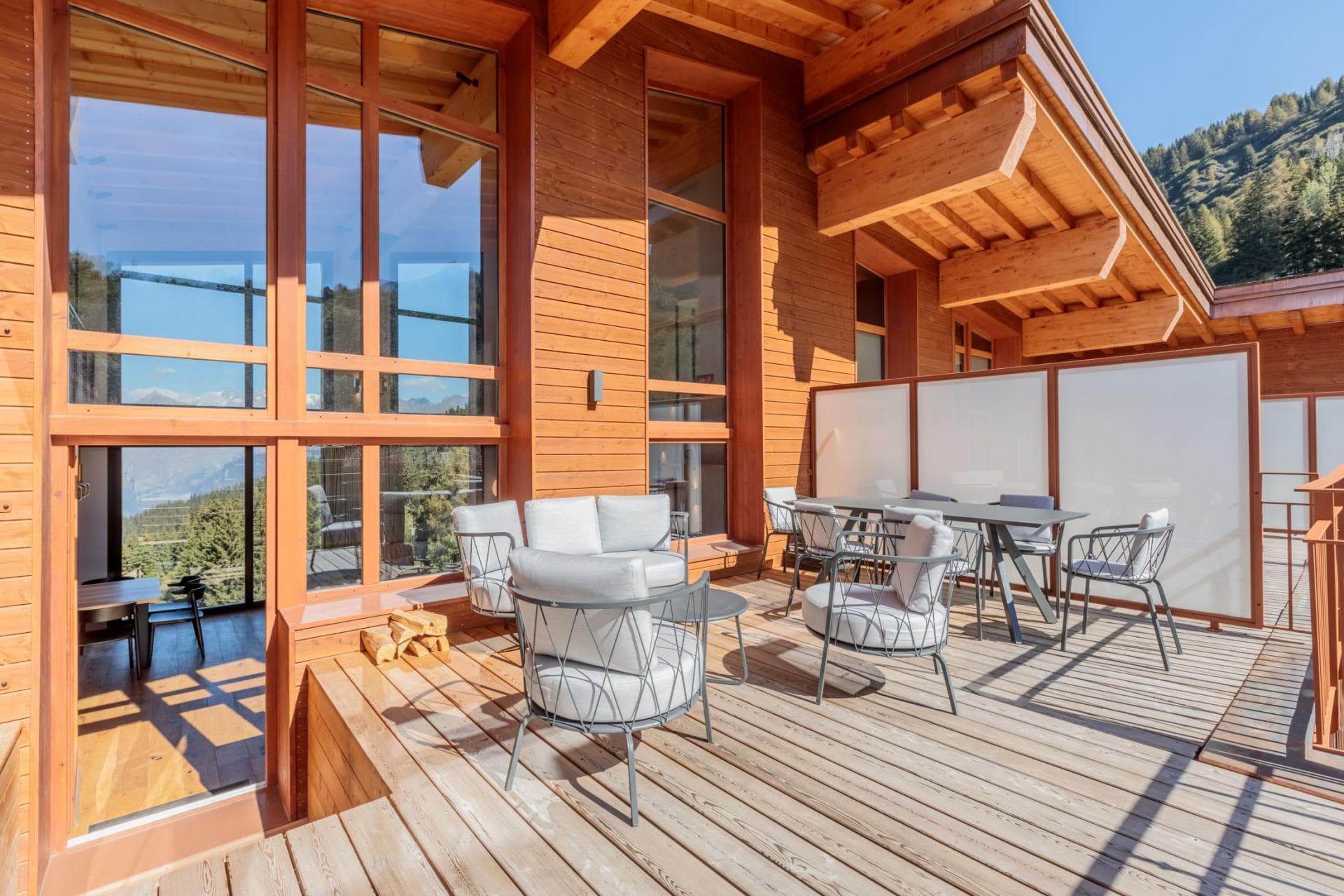 Private timber deck with lounge seating, dining for 6, and privacy screening