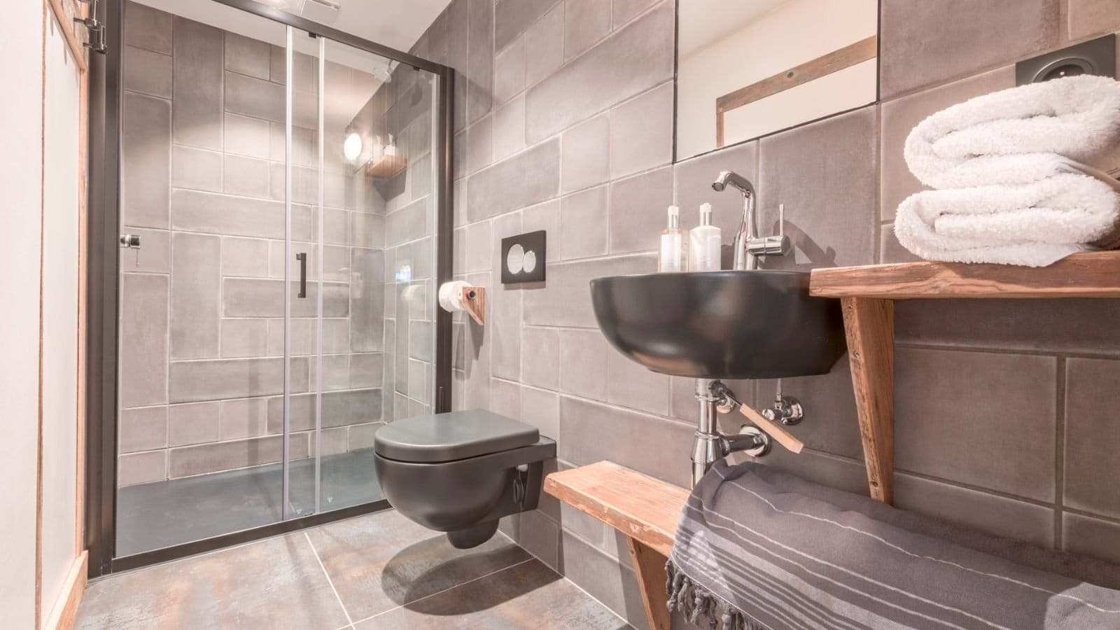 Bathroom with walk-in glass shower and vessel sink