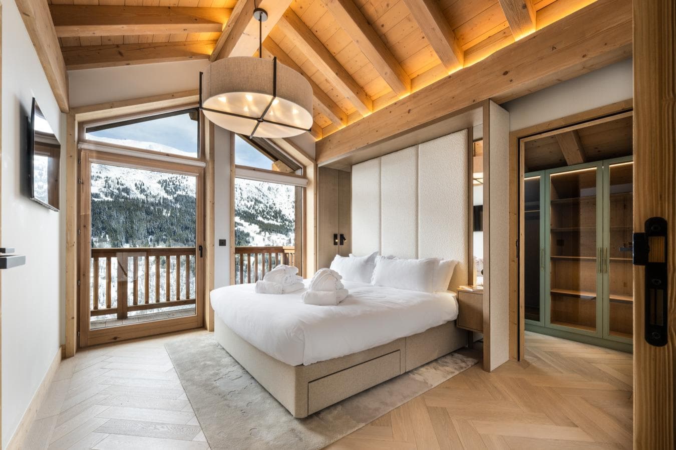 Primary bedroom with king bed and private mountain-view balcony