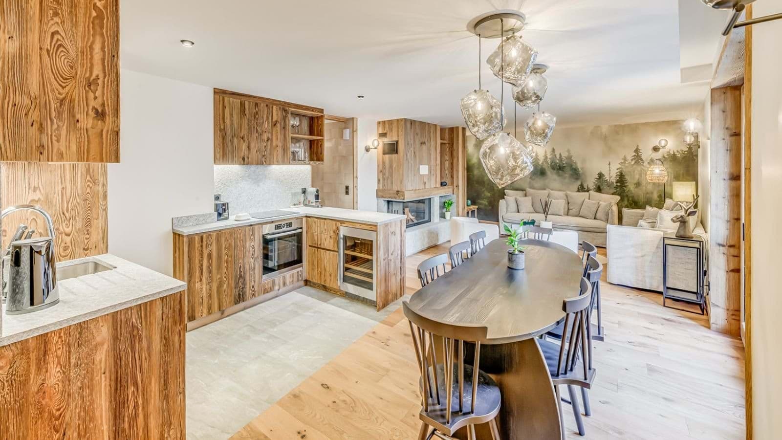 Open-plan kitchen and dining area with wine fridge and wood-burning fireplace