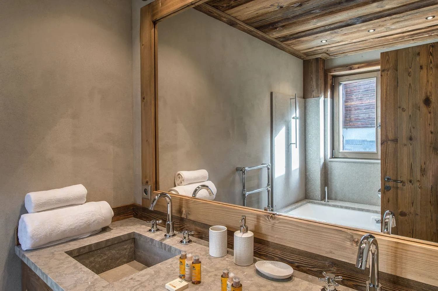 En-suite bathroom with bathtub, double basin and heated towel rail