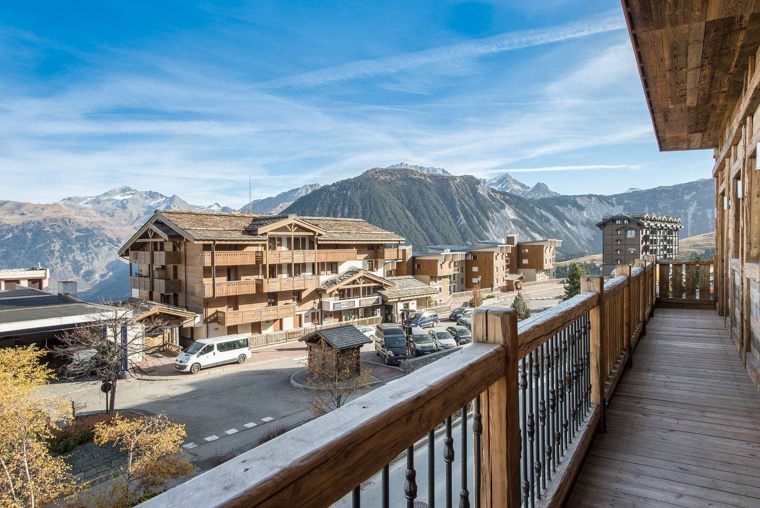 Private wooden balcony with mountain views and resort village outlook