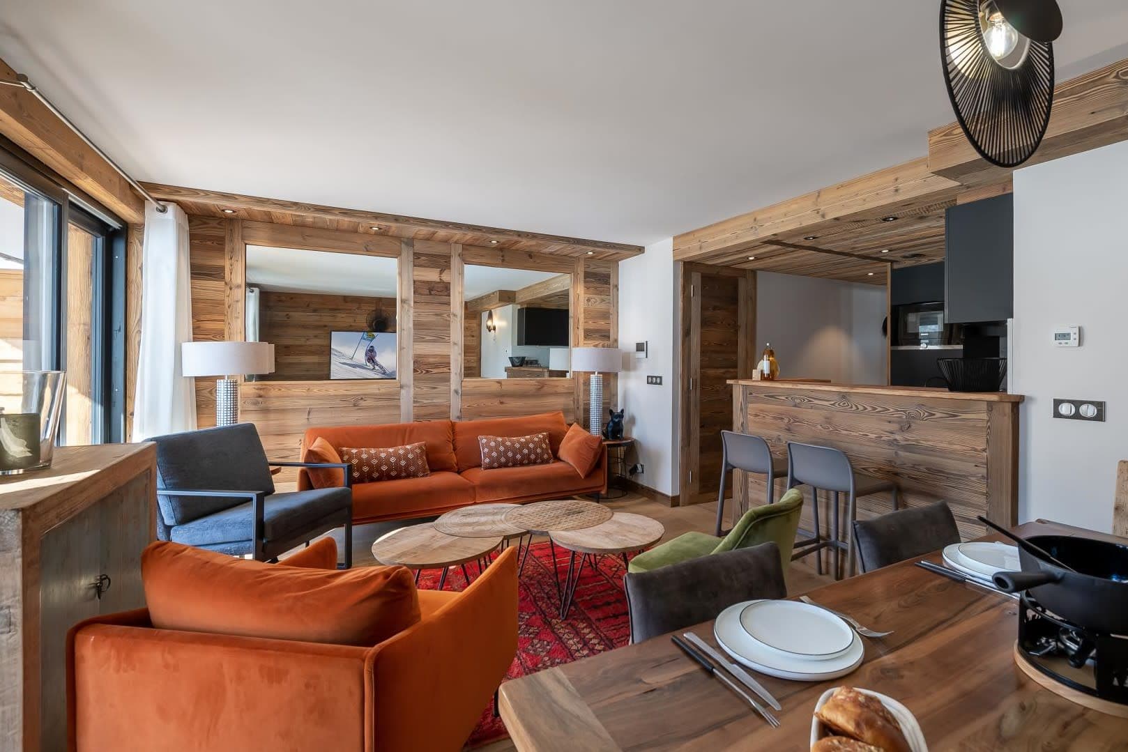 Open-plan living area with breakfast bar seating and fondue set