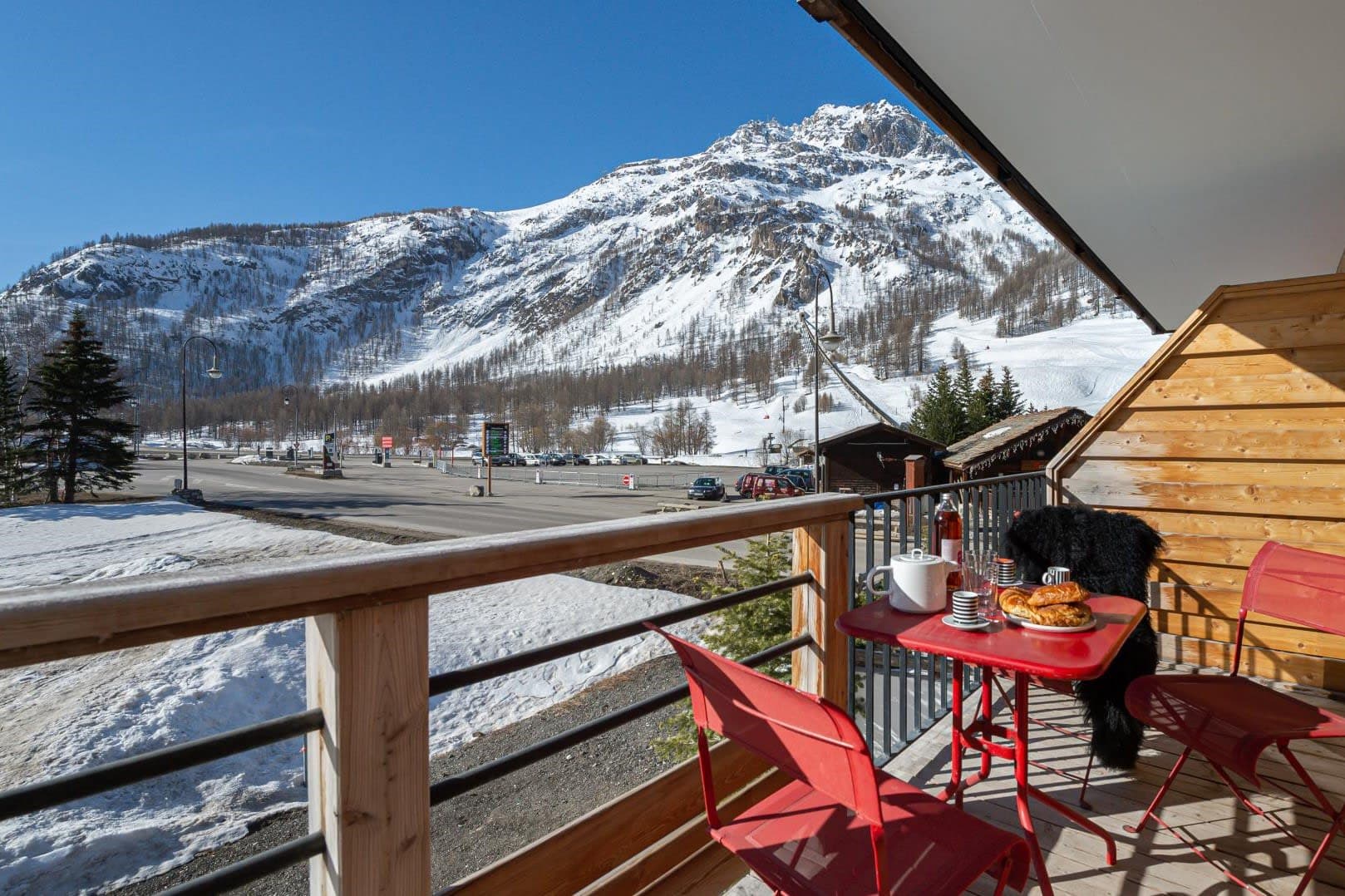 Private balcony with bistro seating and panoramic views of Alpine peaks