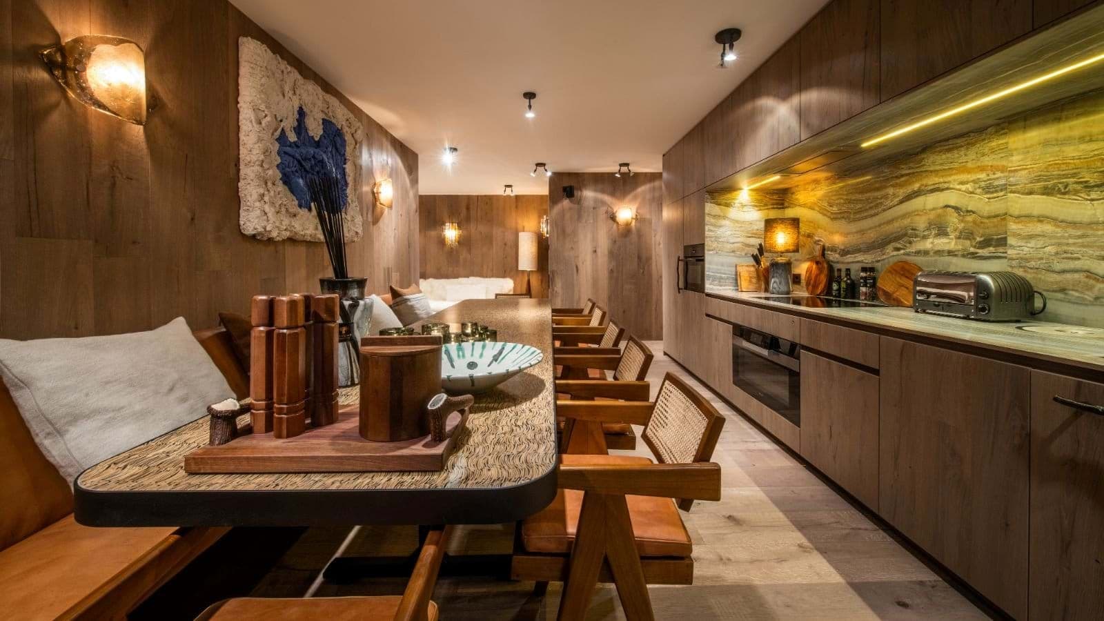 Galley kitchen and dining area with banquette seating for eight