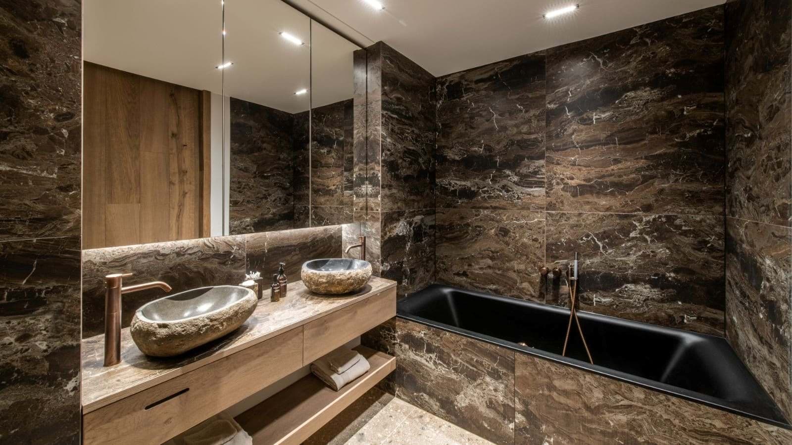 Bathroom with dual stone vessel sinks and deep soaking tub