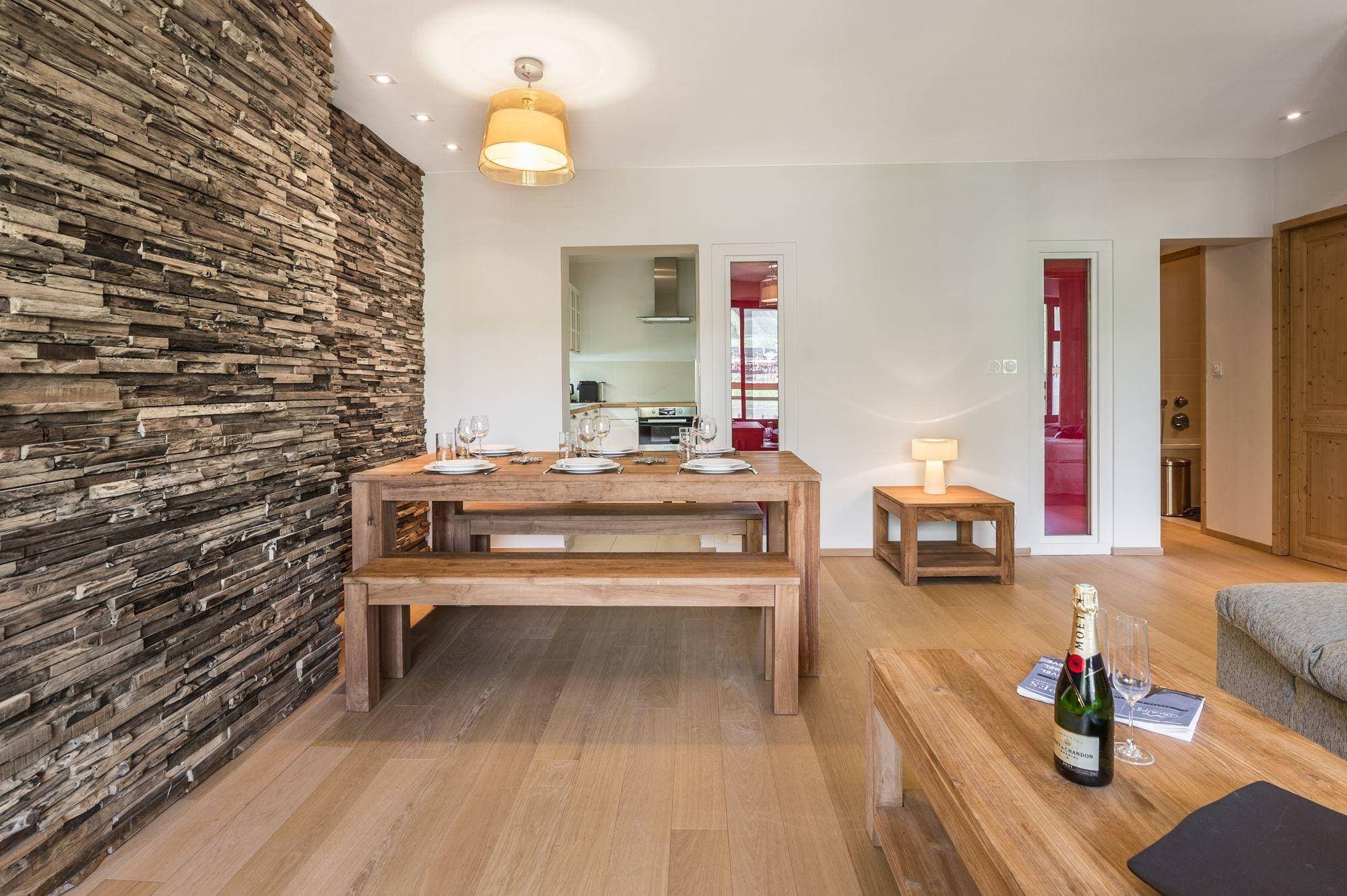 Dining area with bench seating for six and reclaimed wood feature wall