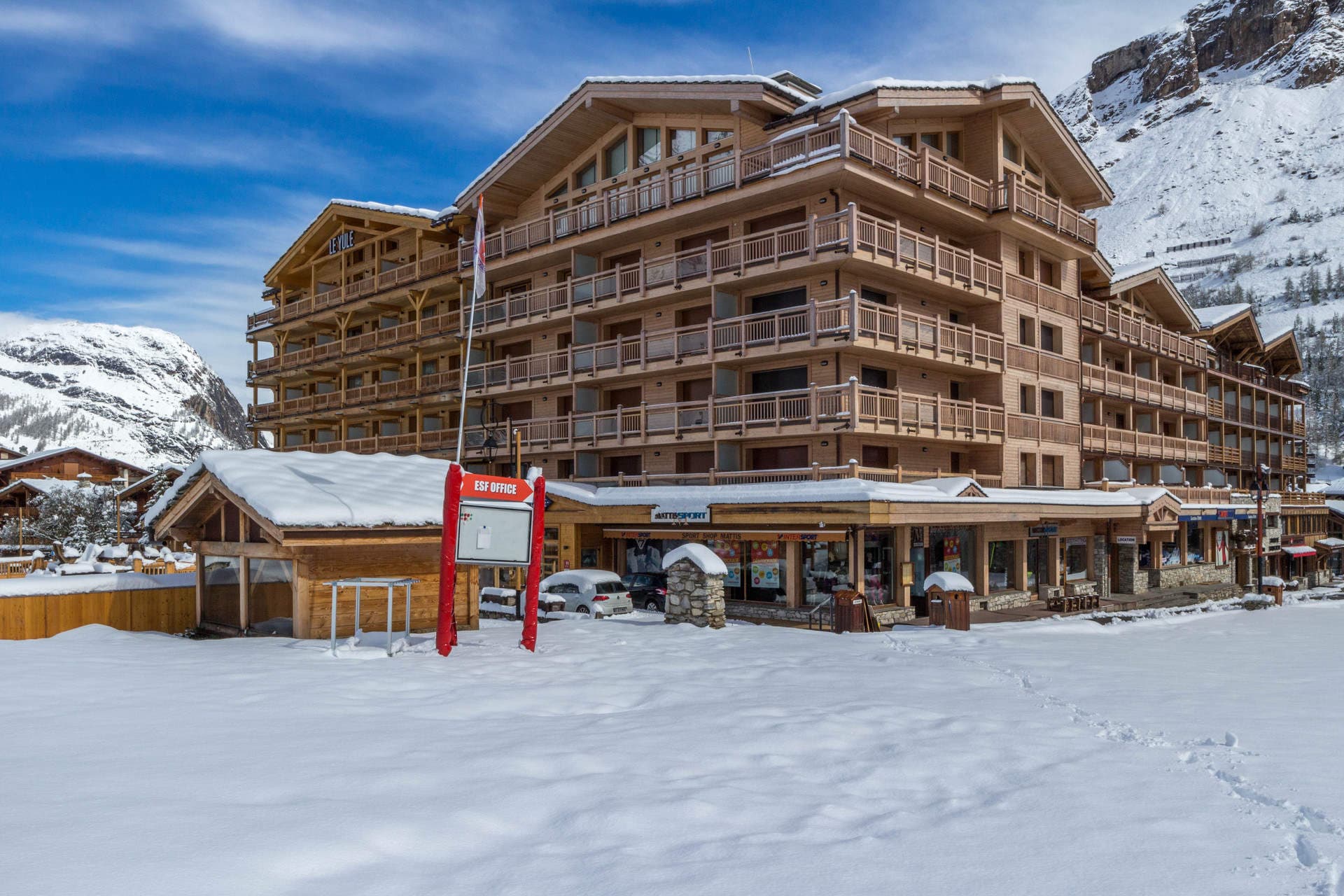 Ski-in/ski-out chalet exterior with ground-floor equipment rental and ESF office