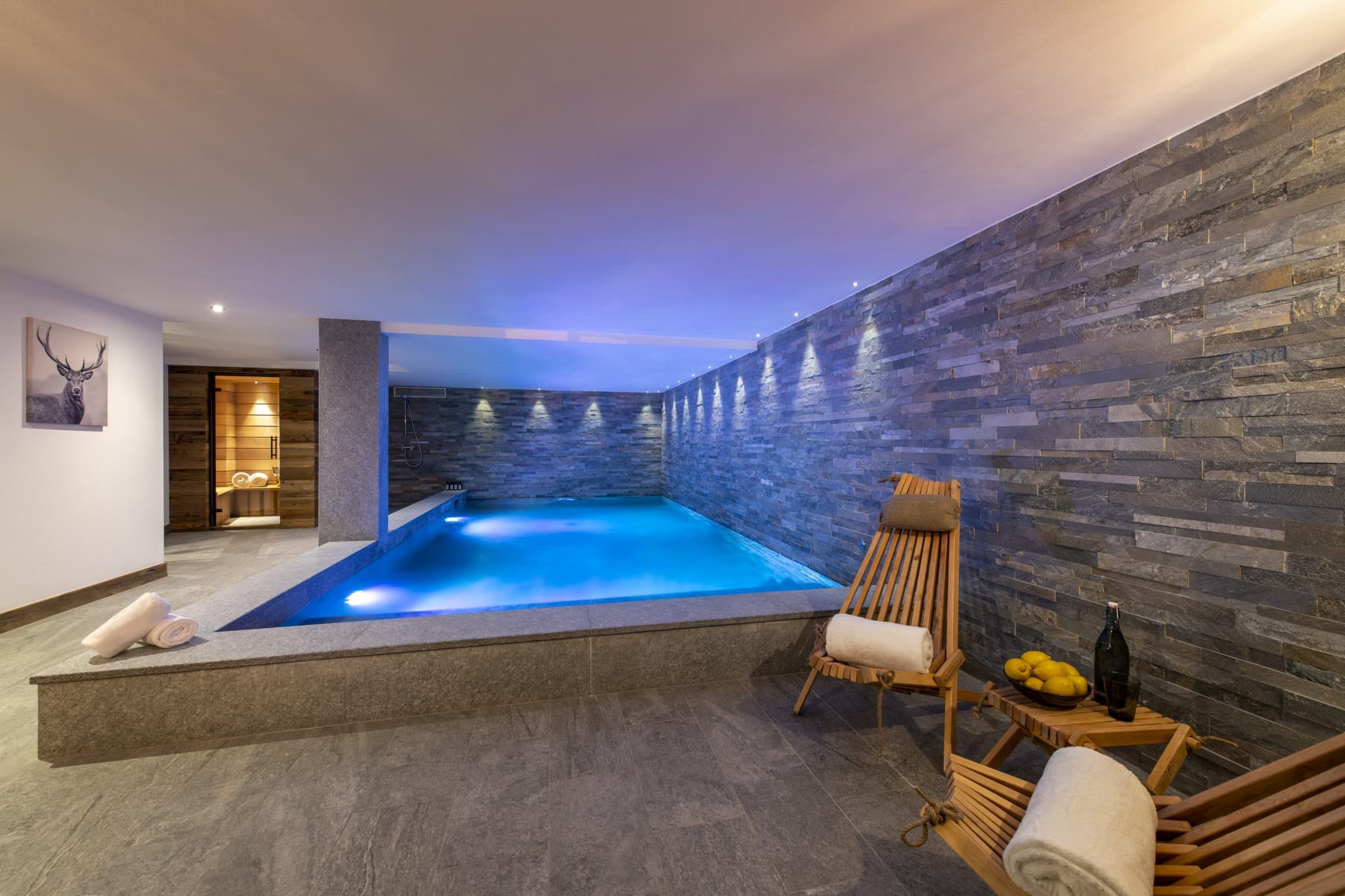 Indoor pool and stone spa area with private sauna