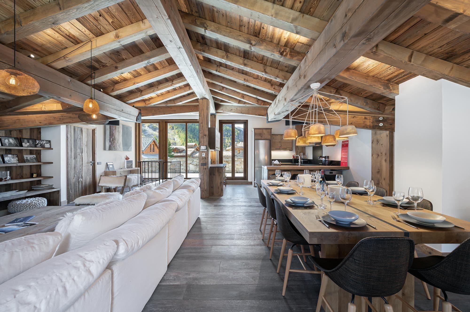 Open-plan living area with vaulted timber ceilings and dining for 10