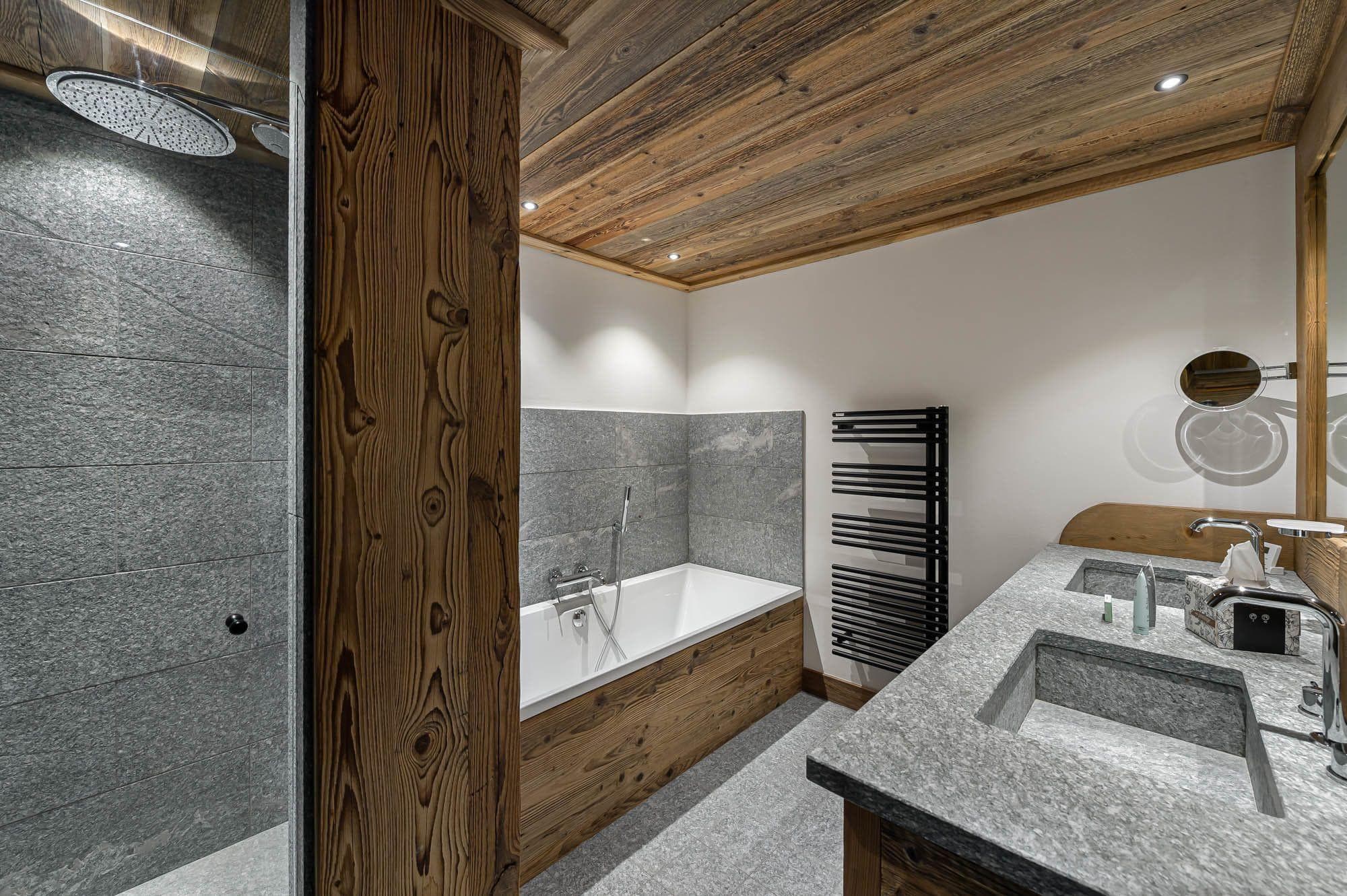 Bathroom with rainfall shower, soaking tub, and heated towel rack