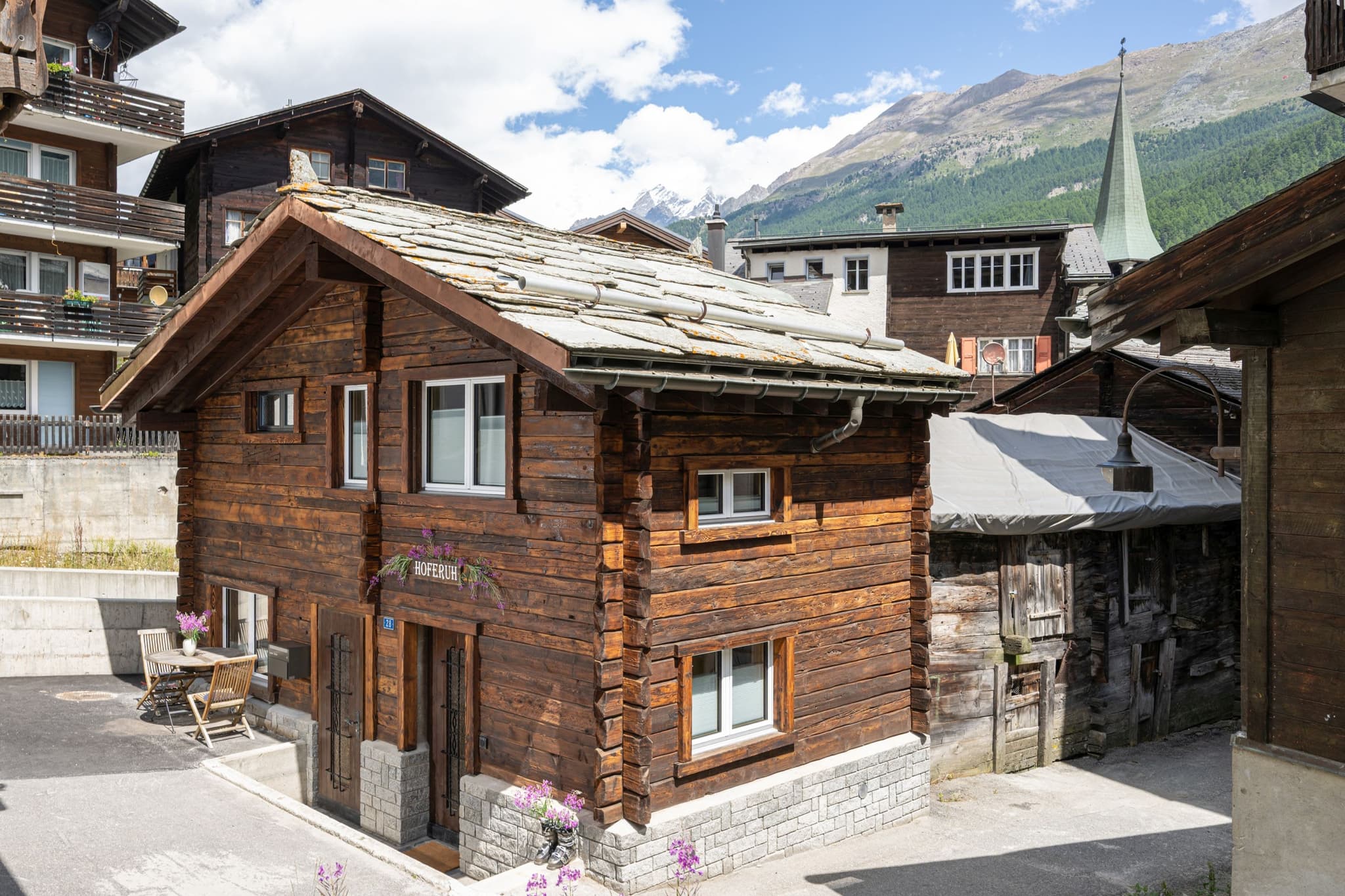 Detached timber chalet with stone roof and private outdoor seating