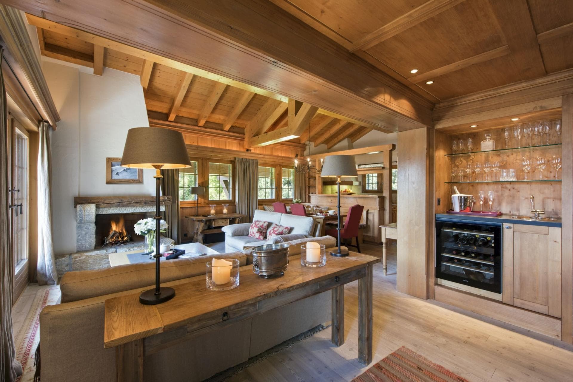 Open living area with wood-burning fireplace and built-in wine fridge
