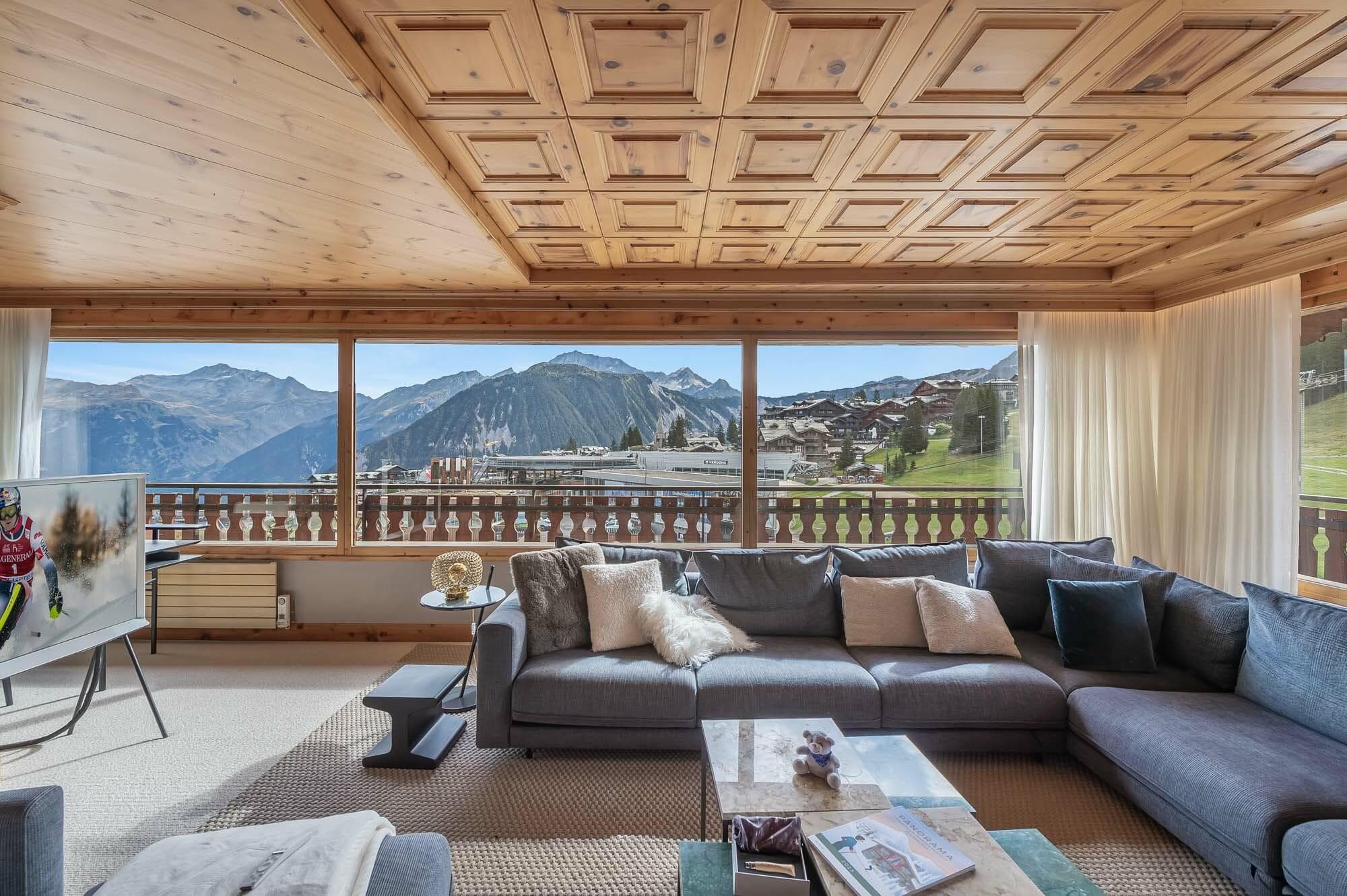 Living area with coffered wood ceiling and panoramic alpine views