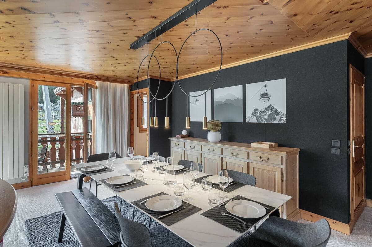 Dining area with seating for 8 and balcony access to ski lift views