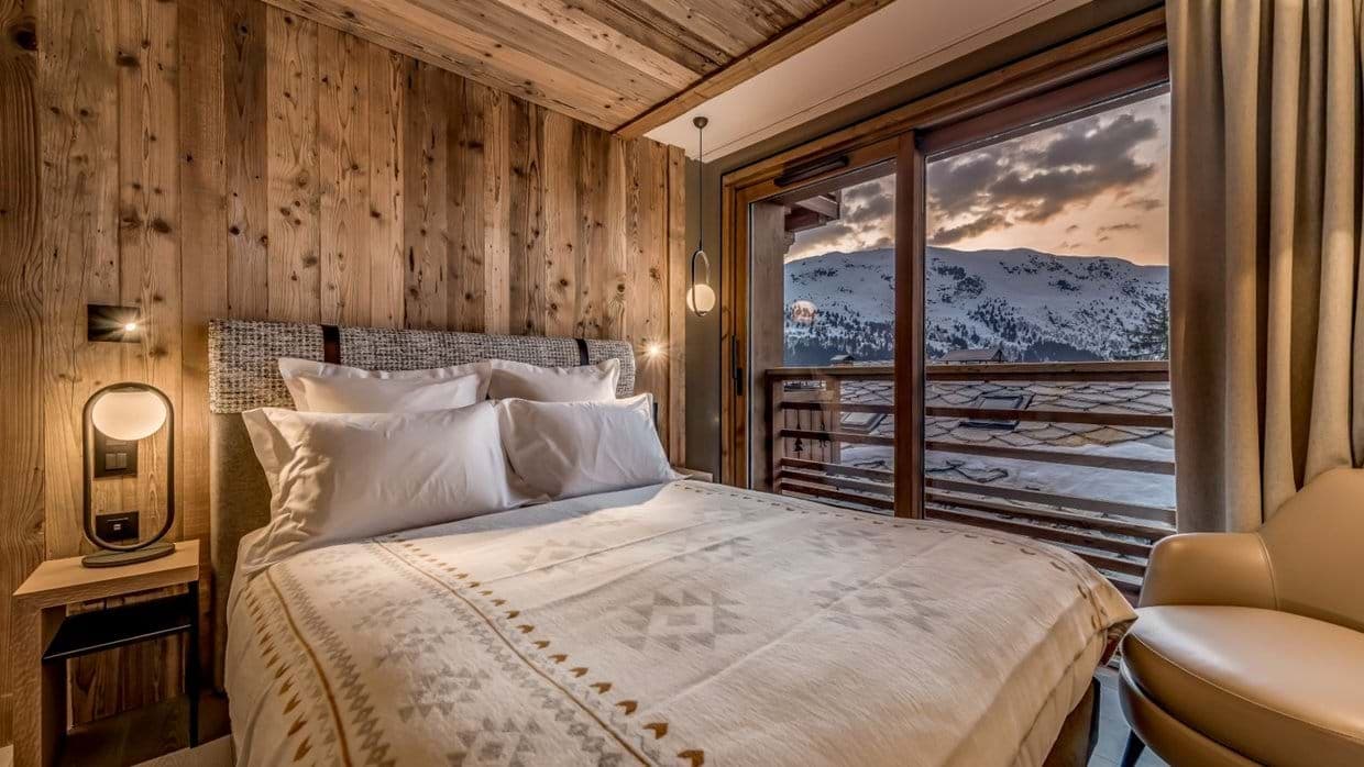 Bedroom with king bed and balcony access to mountain views