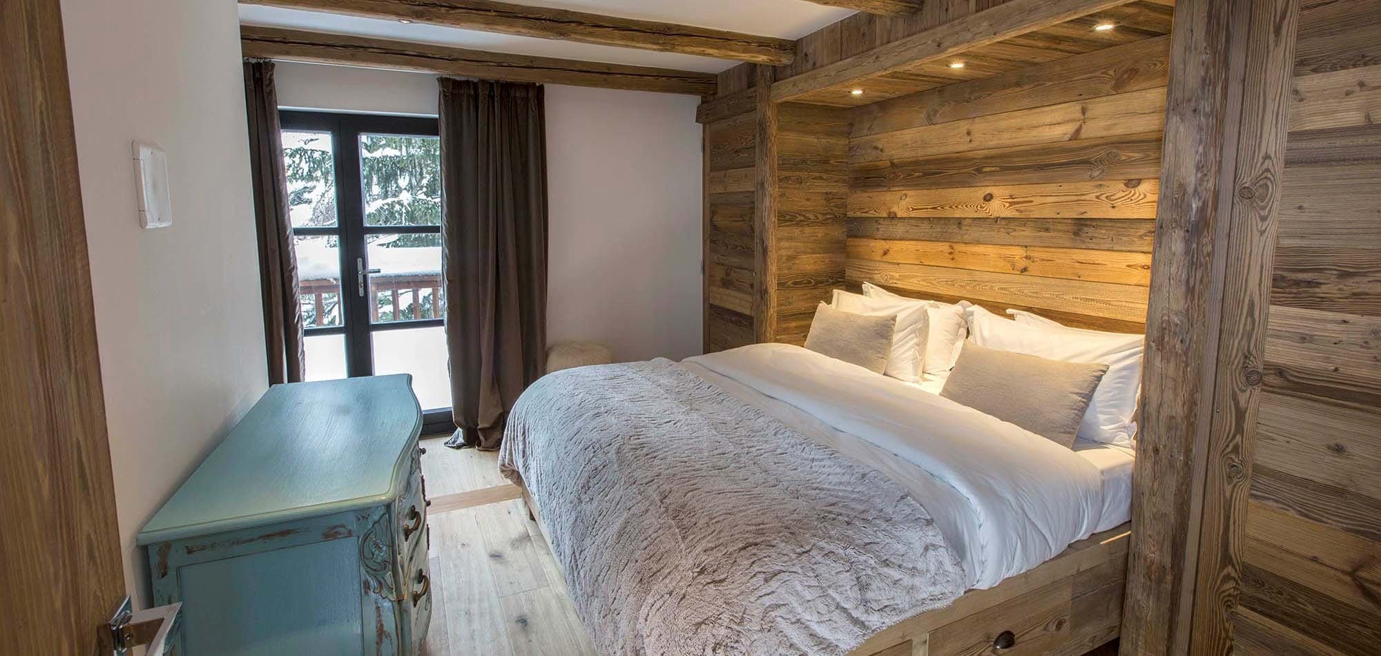 Guest bedroom with queen bed and private balcony access