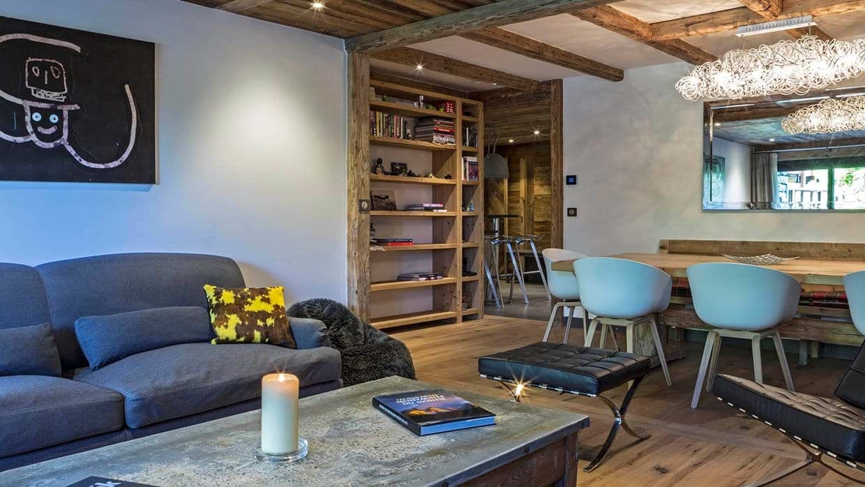 Open living area with timber-beamed ceilings and dining seating for 8