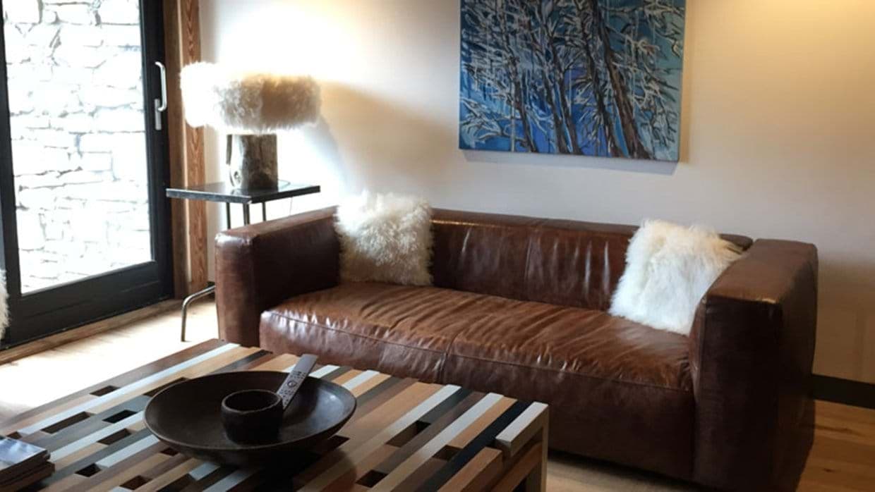 Living area with leather sofa and terrace access