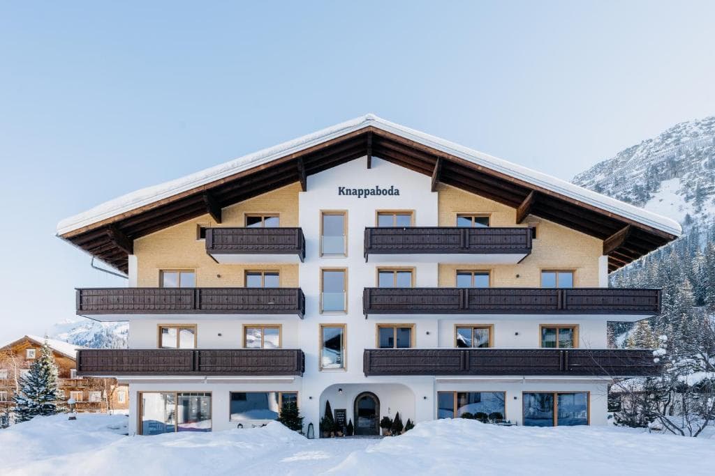 Chalet exterior featuring private balconies and snowy mountain backdrop